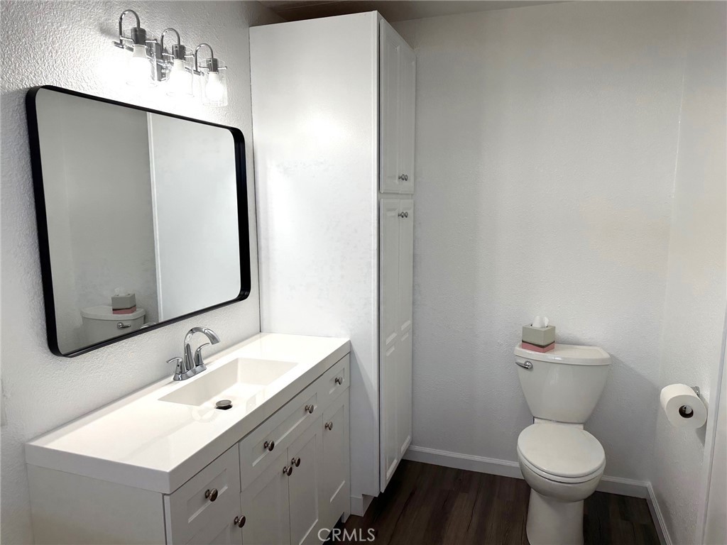 15181 Van Buren Boulevard, Unit 57 Riverside, CA 92504 - Photo 18 of 40 a bathroom with a sink toilet and a mirror