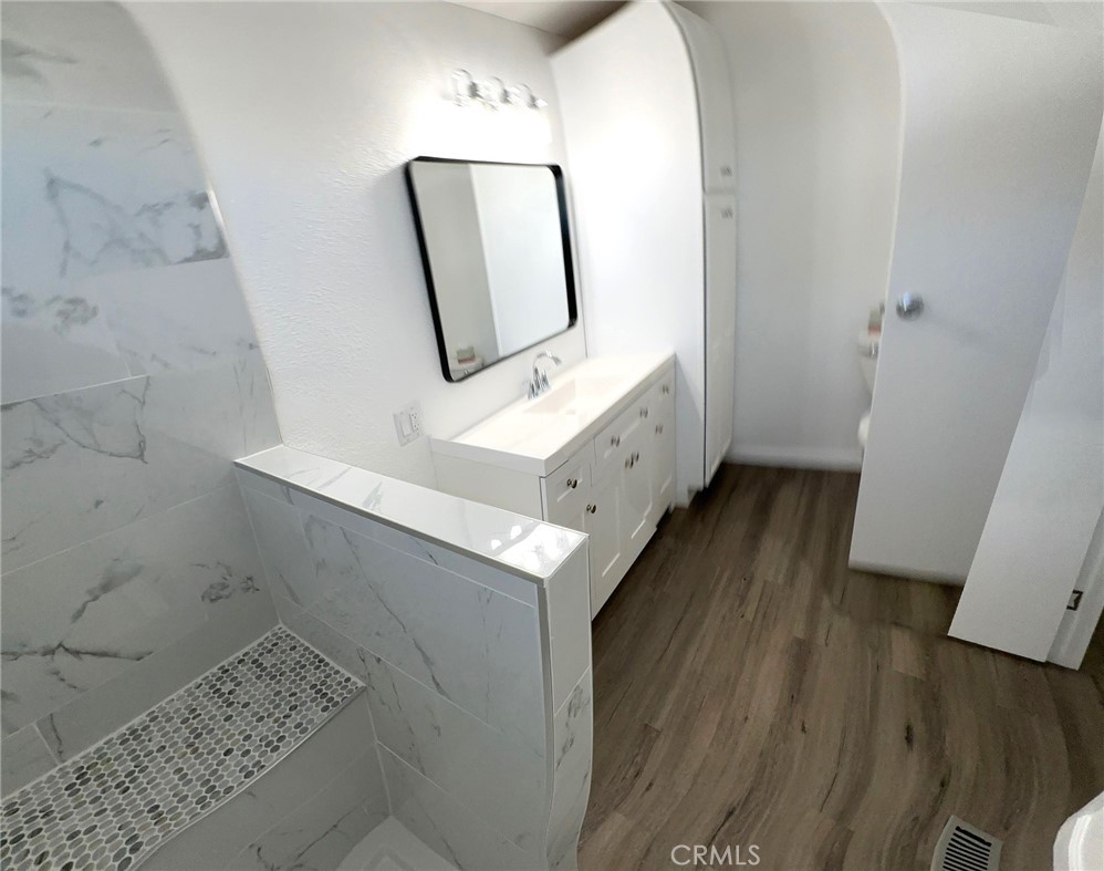 15181 Van Buren Boulevard, Unit 57 Riverside, CA 92504 - Photo 20 of 40 a bathroom with a mirror and a sink