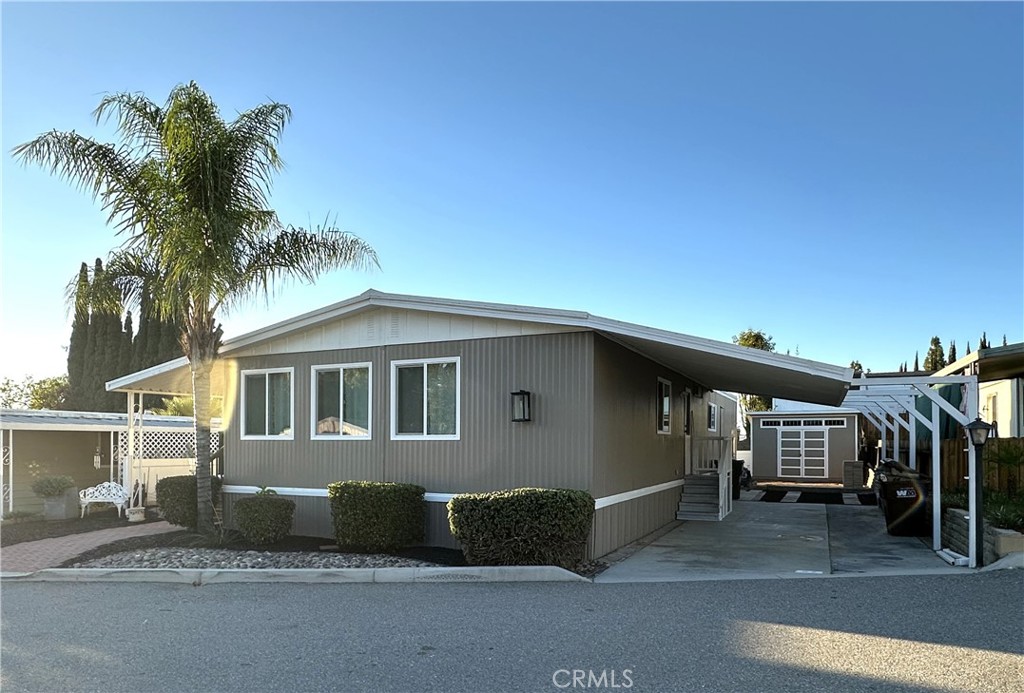 15181 Van Buren Boulevard, Unit 57 Riverside, CA 92504 - Photo 2 of 40 a front view of a house with a yard