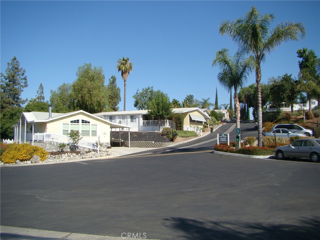 15181 Van Buren Boulevard, Unit 57 Riverside, CA 92504 - Photo 22 of 40 a couple of cars parked in front of a house
