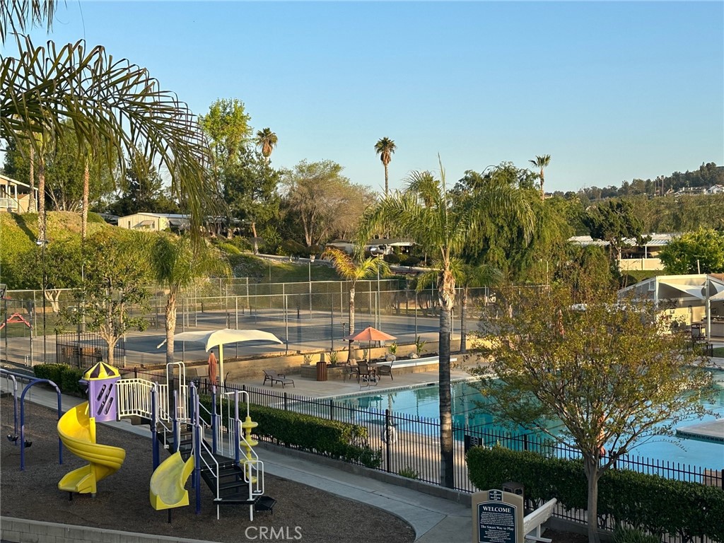 15181 Van Buren Boulevard, Unit 57 Riverside, CA 92504 - Photo 28 of 40 a view of a lake with a table and chairs