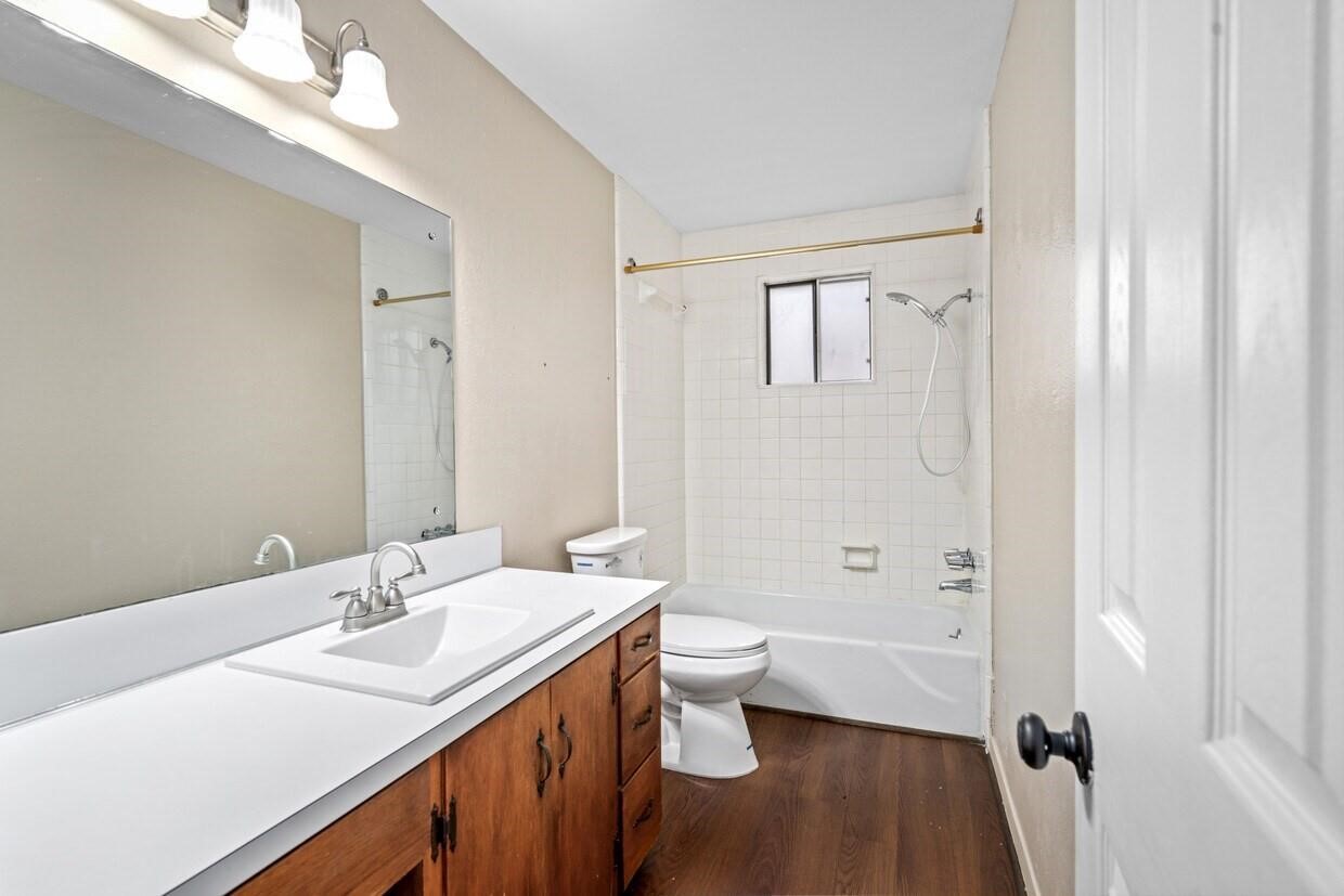 401 East Main Street, Unit 8 Brenham, TX 77833 - Photo 14 of 20 a bathroom with a double vanity sink toilet and shower
