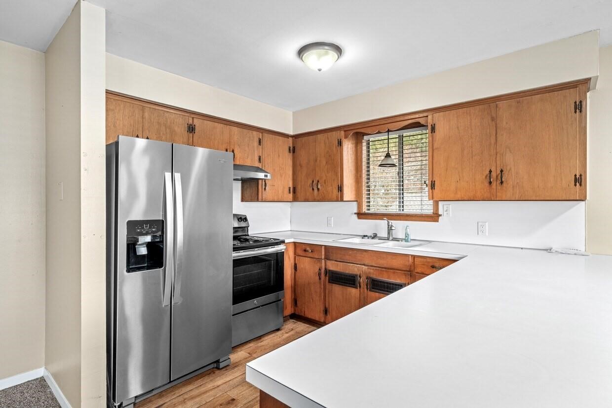 401 East Main Street, Unit 8 Brenham, TX 77833 - Photo 10 of 20 a kitchen with stainless steel appliances granite countertop a refrigerator a sink and a stove