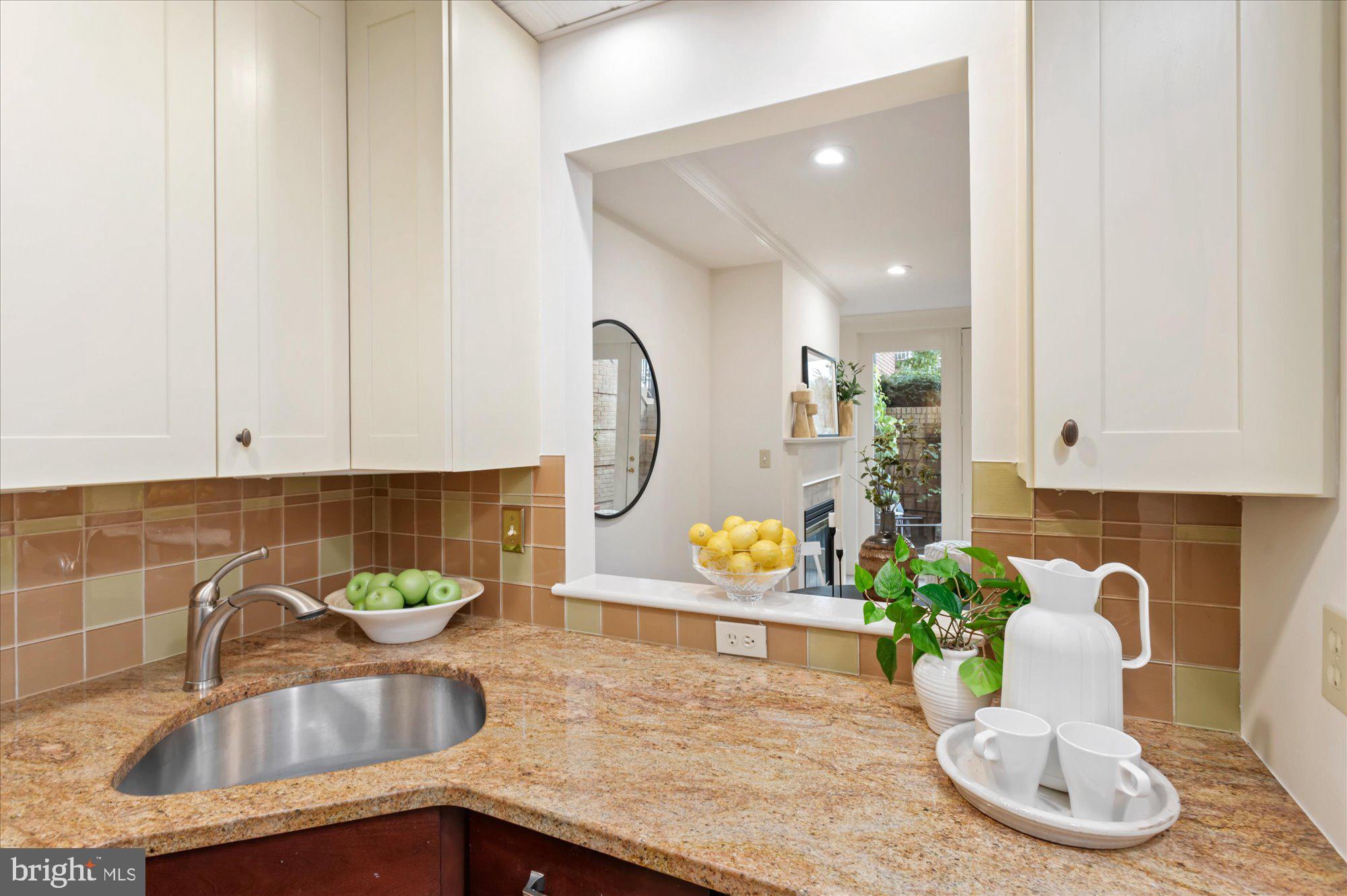 1913 Kalorama Place Northwest, Unit 13 Washington, DC 20009 - Photo 15 of 33 a kitchen with a faucet a sink and a white cabinets