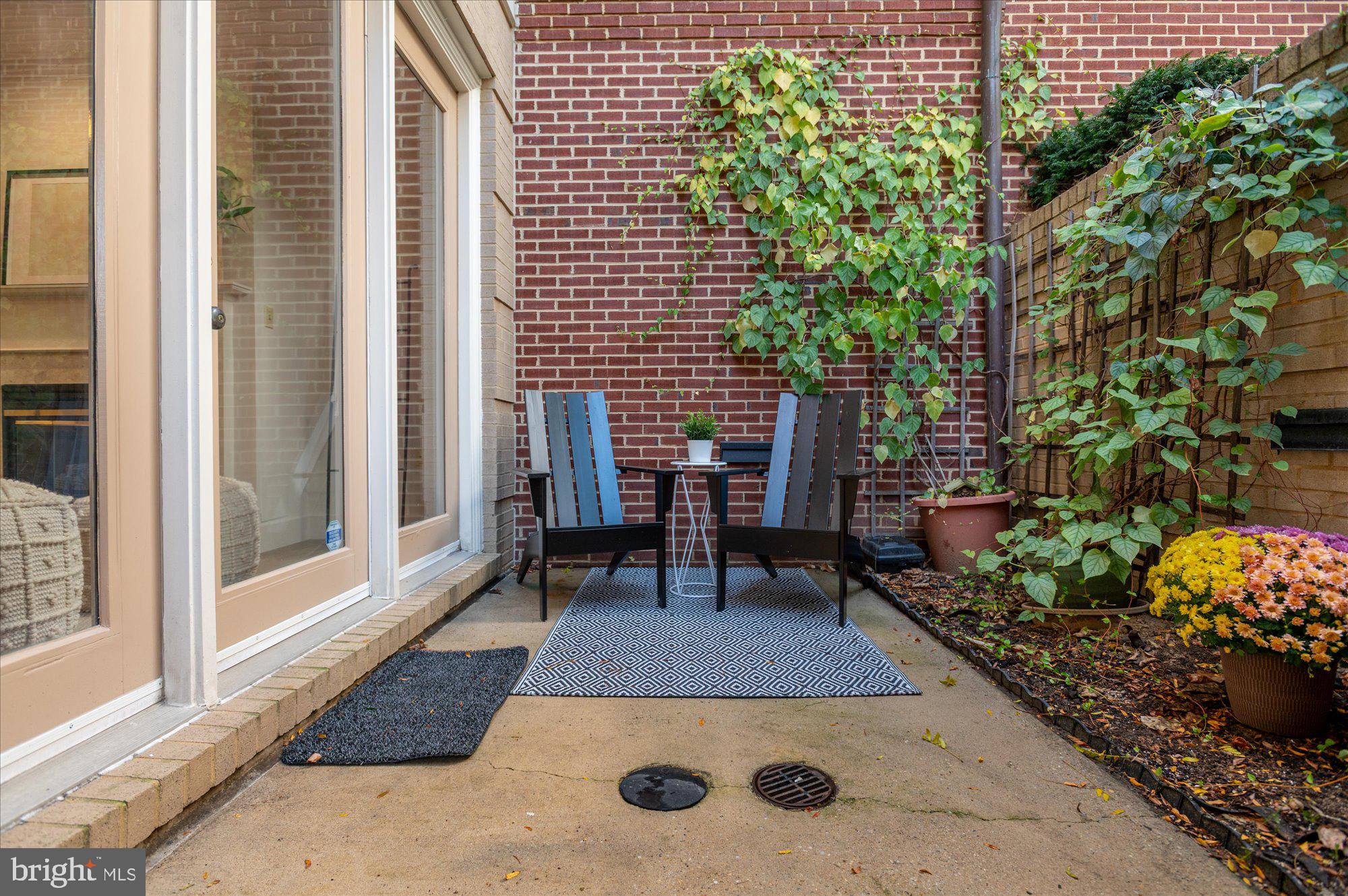 1913 Kalorama Place Northwest, Unit 13 Washington, DC 20009 - Photo 16 of 33 a view of a patio with table and chairs and potted plants