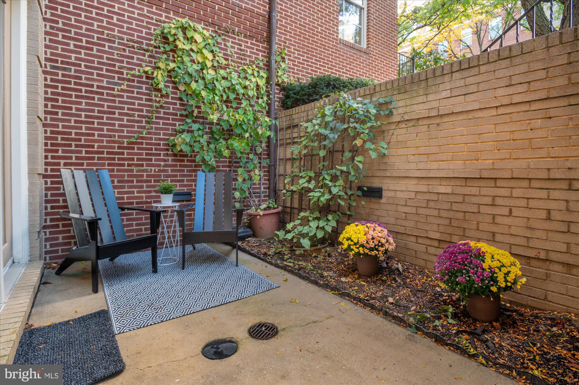 1913 Kalorama Place Northwest, Unit 13 Washington, DC 20009 - Photo 17 of 33 a view of a chairs and table in a backyard