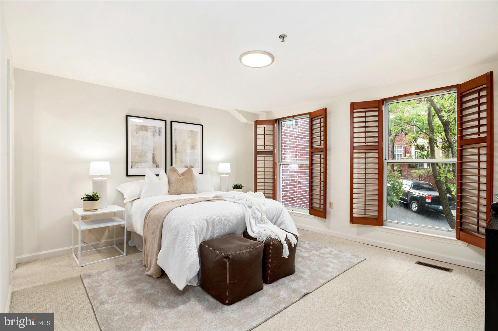 1913 Kalorama Place Northwest, Unit 13 Washington, DC 20009 - Photo 21 of 33 a spacious bedroom with a bed and large windows