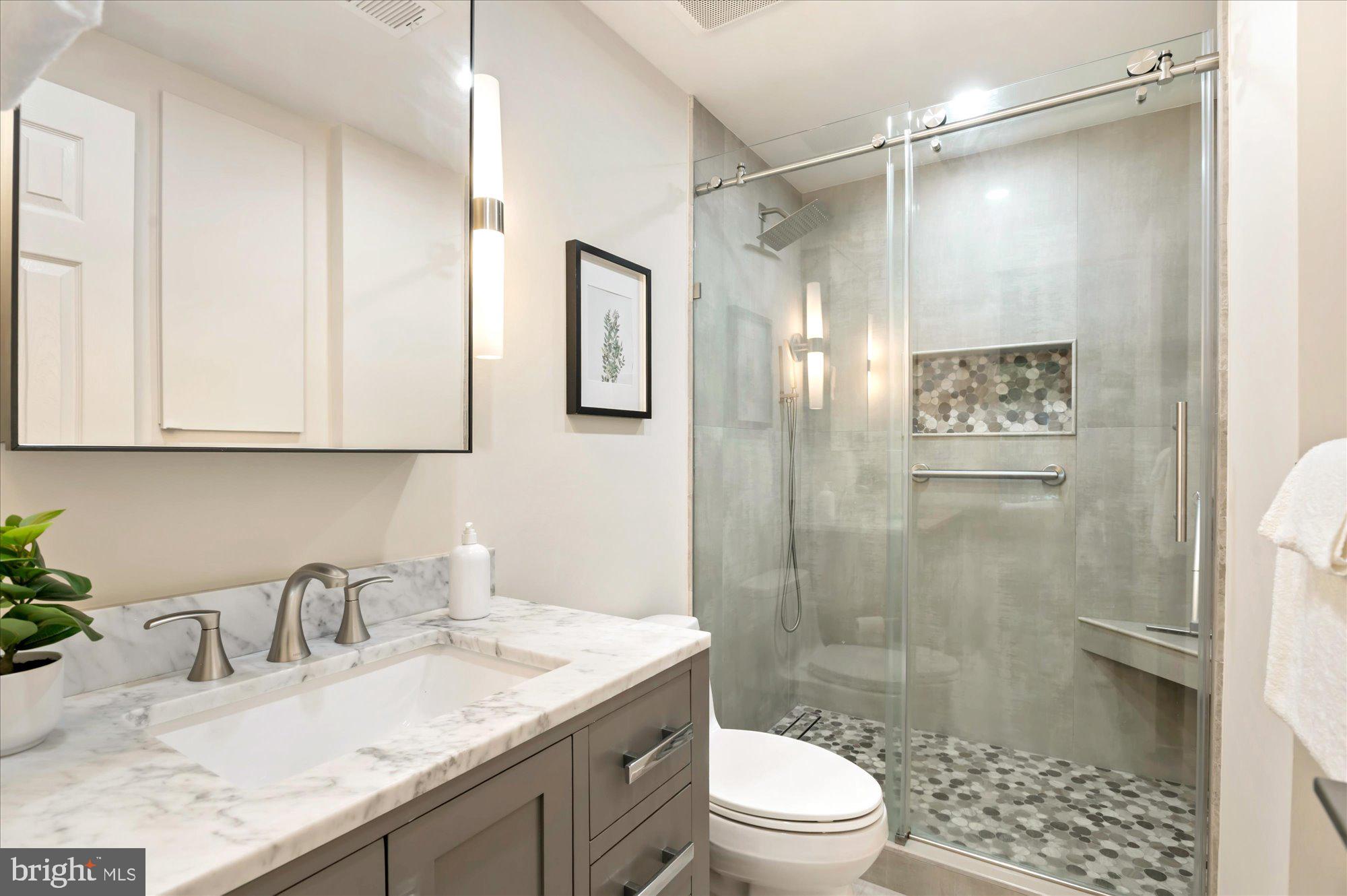 1913 Kalorama Place Northwest, Unit 13 Washington, DC 20009 - Photo 24 of 33 a bathroom with a granite countertop sink toilet and shower