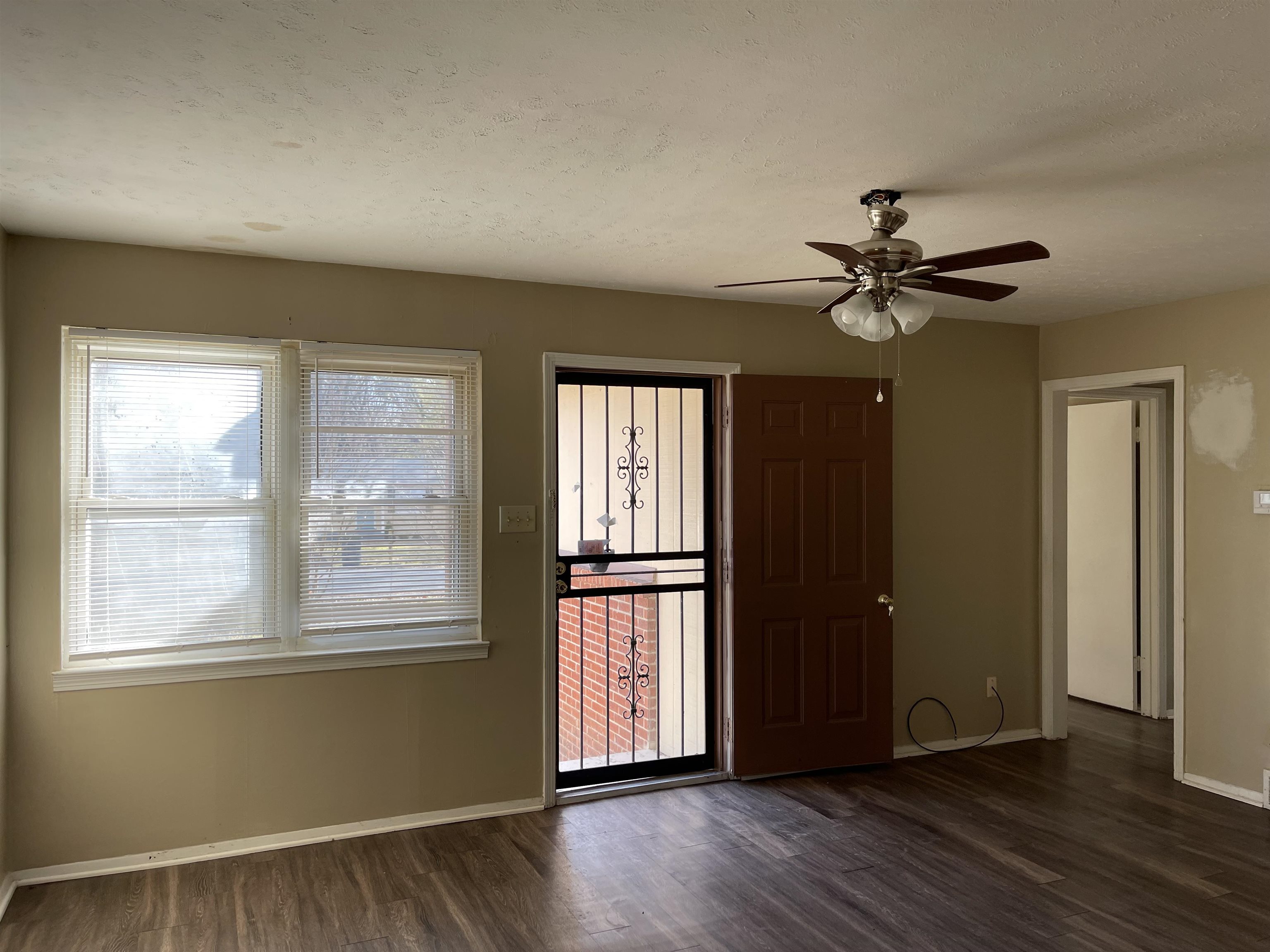 1624 Winfield Road Memphis, TN 38116 - Photo 14 of 14 a view of an empty room with a window and wooden floor