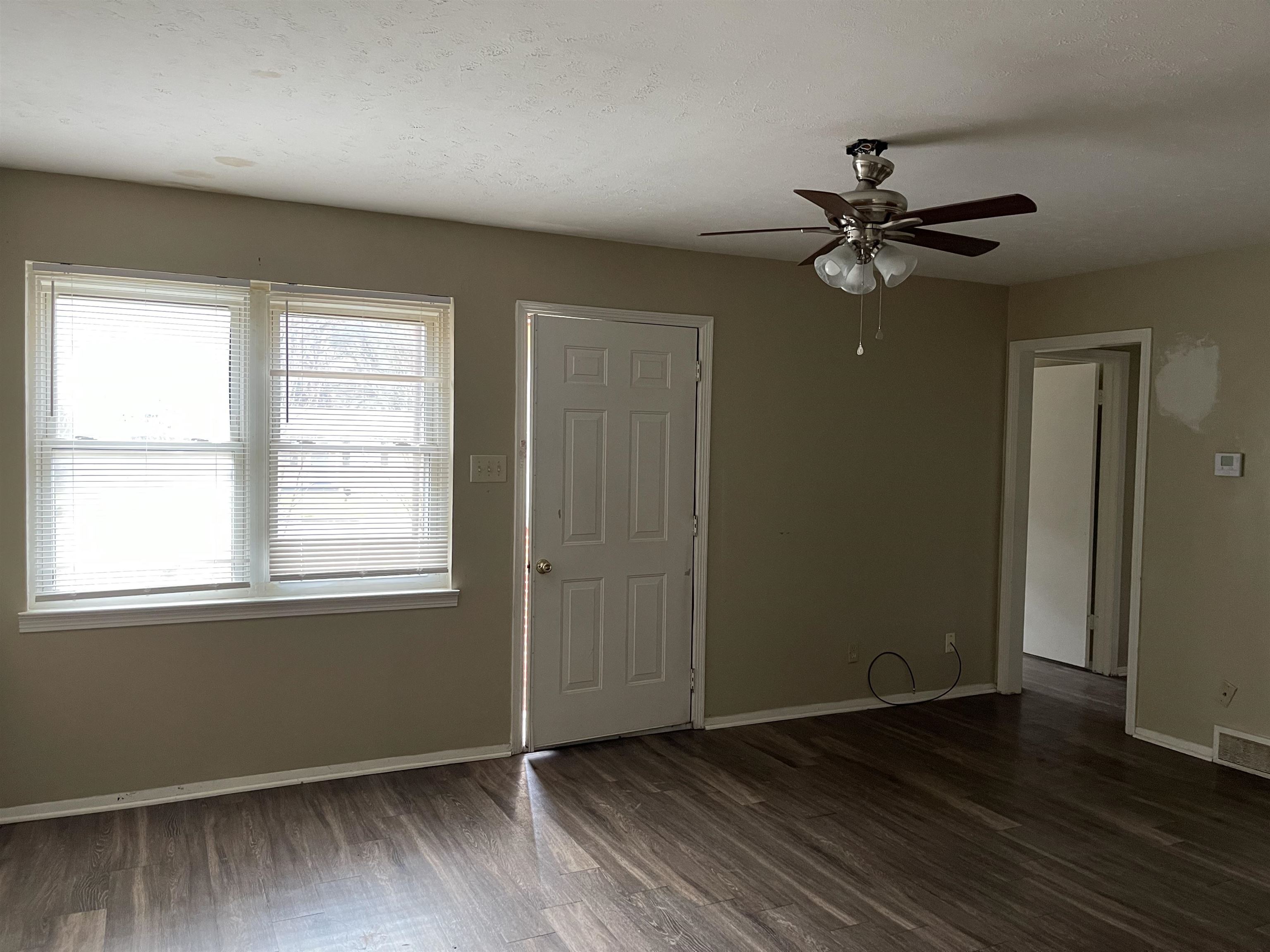 1624 Winfield Road Memphis, TN 38116 - Photo 6 of 14 a view of empty room with wooden floor and fan
