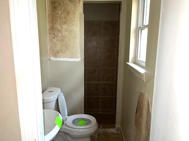 1624 Winfield Road Memphis, TN 38116 - Photo 9 of 14 a white toilet sitting next to a bathroom sink and a window
