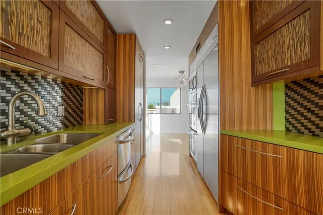 a kitchen with stainless steel appliances granite countertop a refrigerator and a stove