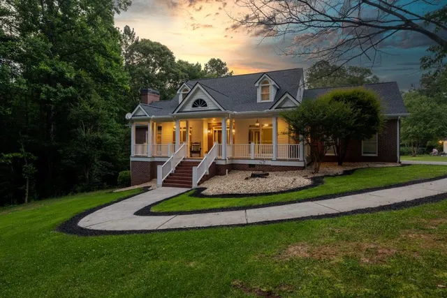 a front view of house with a garden