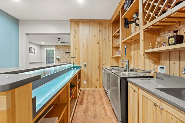 an empty room with windows and a fireplace