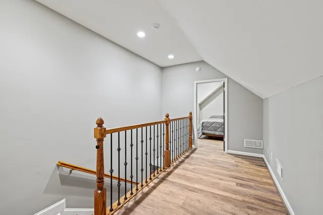 a spacious bathroom with a granite countertop sink mirror and a refrigerator