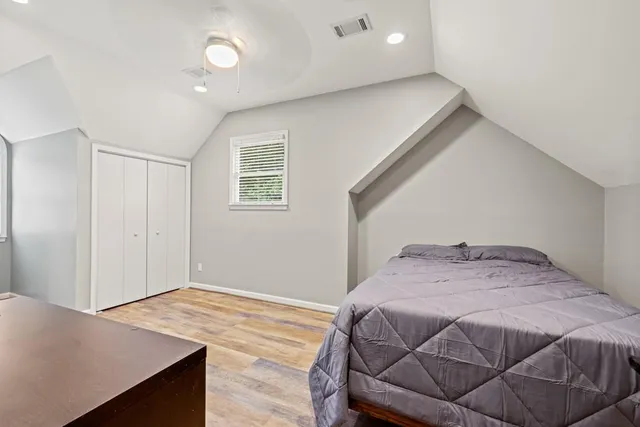 a bedroom with bed and flat screen tv