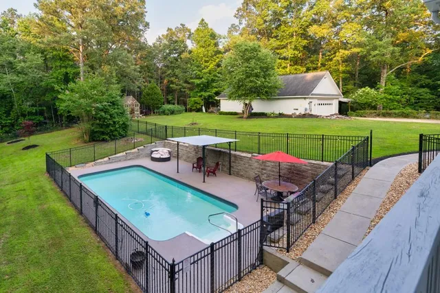 a view of house with yard and green space