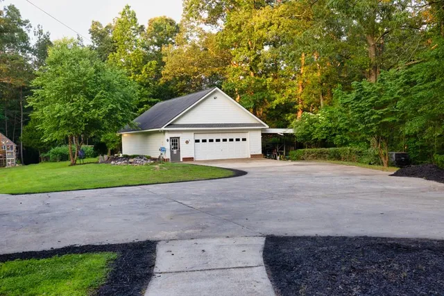 a front view of a house with a yard table and chairs