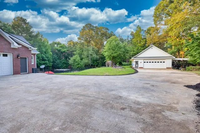 an aerial view of a house with a yard and trees