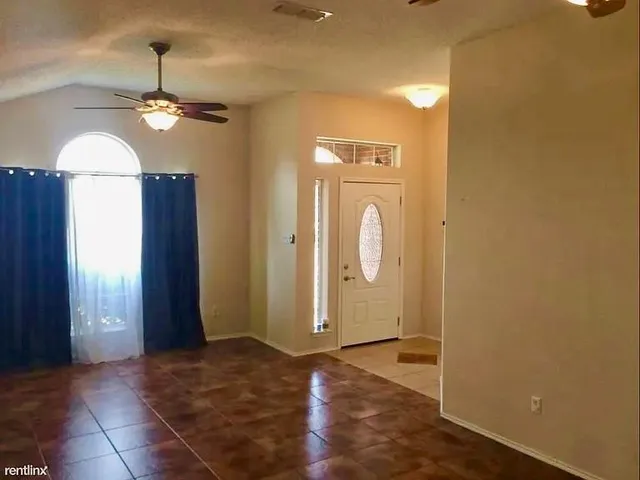 a view of a bathroom with a shower and mirror