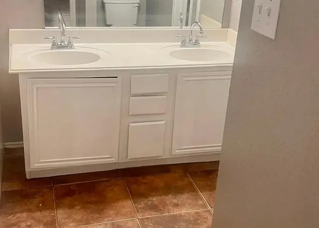 a bathroom with a sink and a mirror