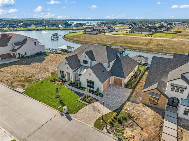 an aerial view of a house with outdoor space and ocean view