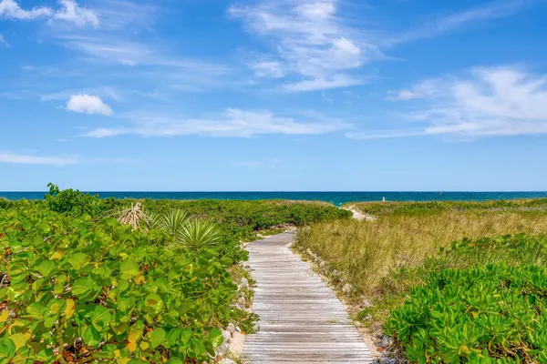 a view of staircase and living room with floor to ceiling windows