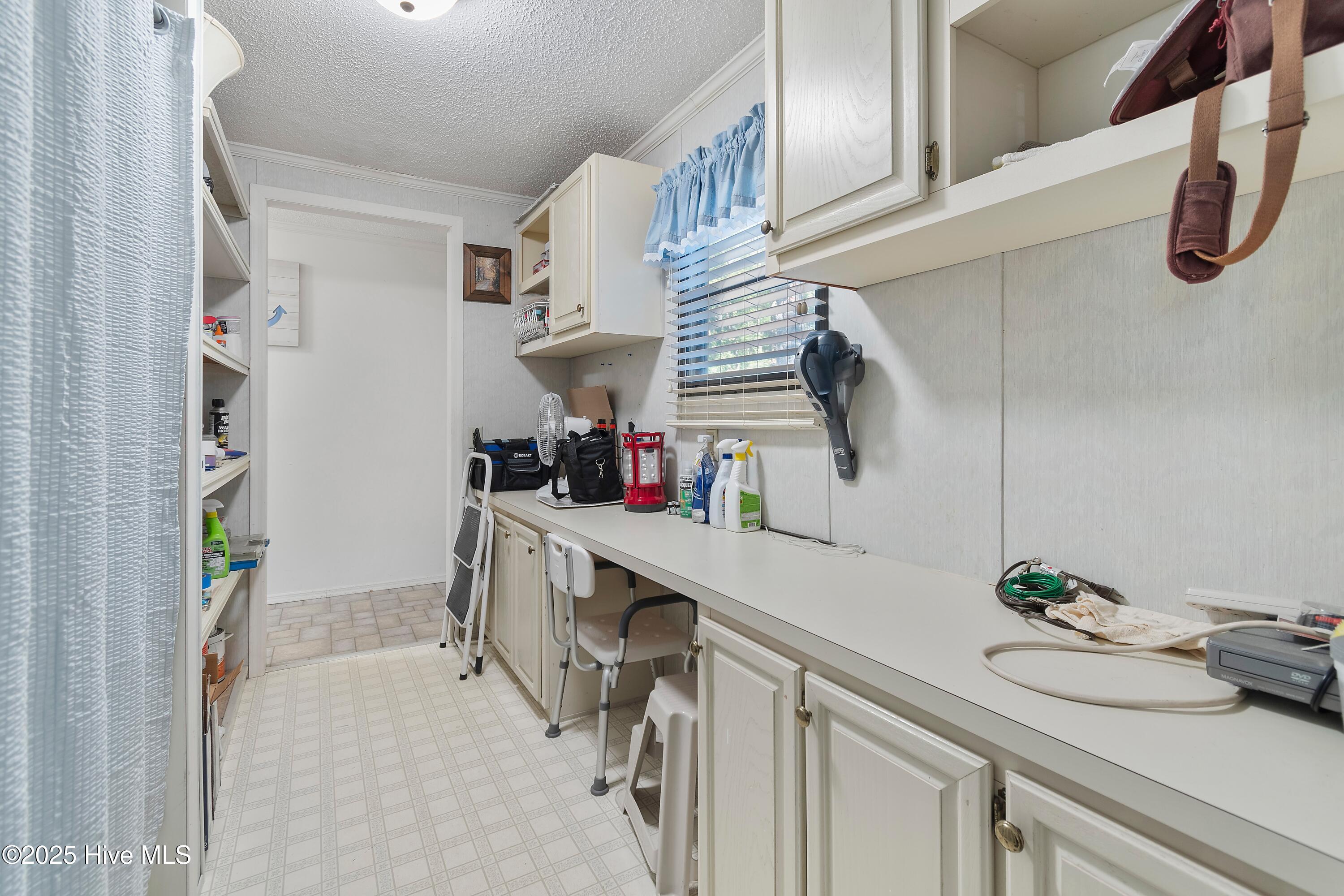 984 Myrtle Court Southwest Calabash, NC 28467 - Photo 15 of 33 Multipurpose Room with Laundry, Pantry, Shelving & Desk