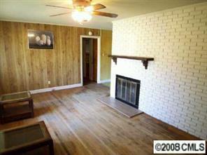 4447 Applegate Road Charlotte, NC 28209 - Photo 3 of 8 a view of a livingroom with wooden floor and a fireplace