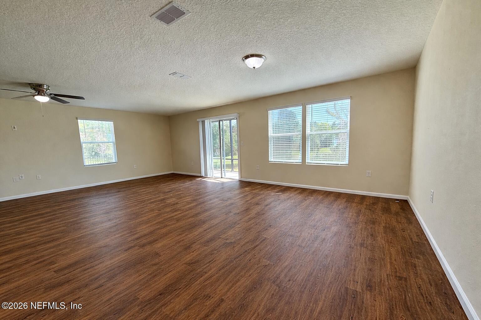 234 Cody Street St. Augustine, FL 32084 - Photo 11 of 20 an empty room with wooden floor and windows