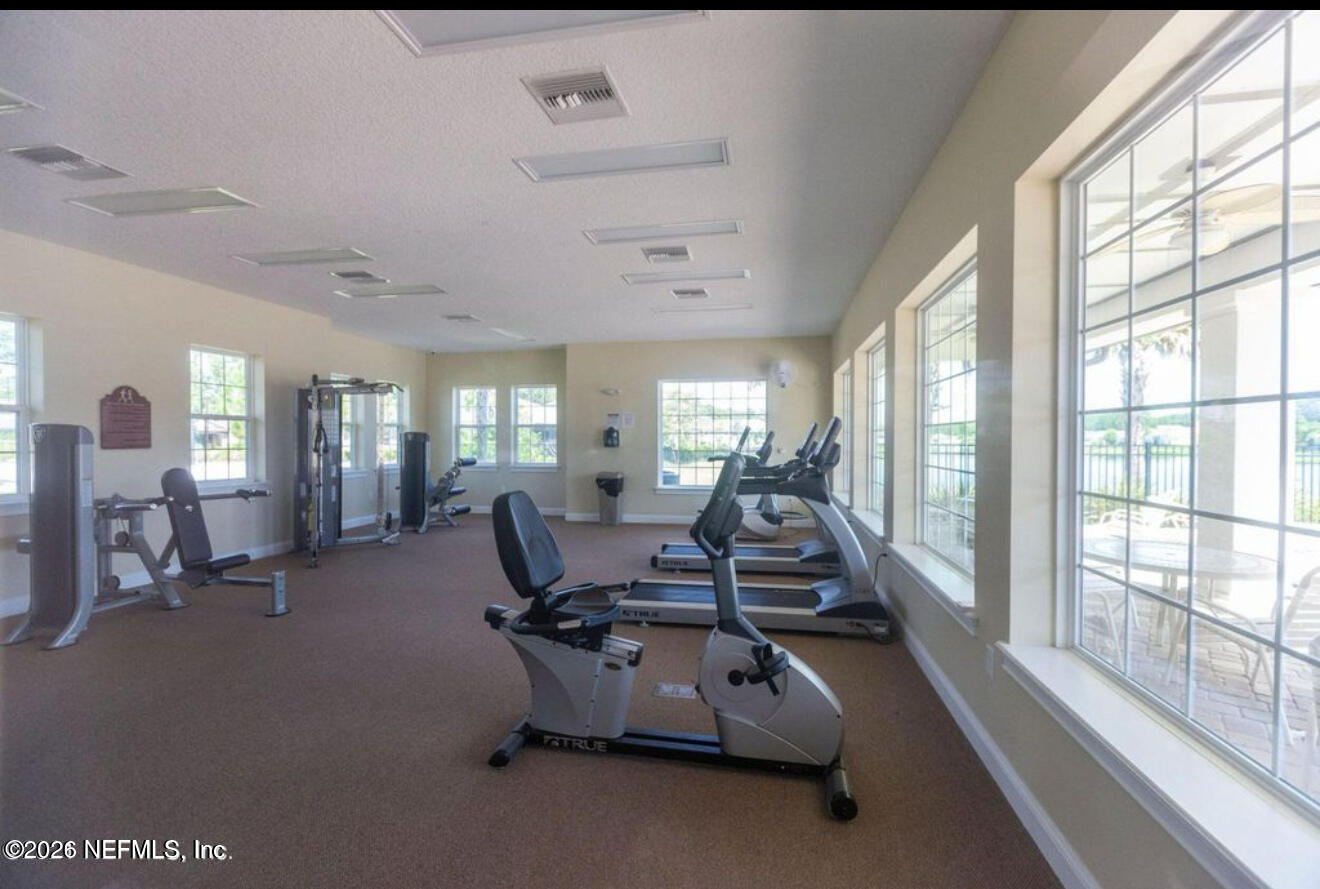 234 Cody Street St. Augustine, FL 32084 - Photo 16 of 20 a room with gym equipment and large windows