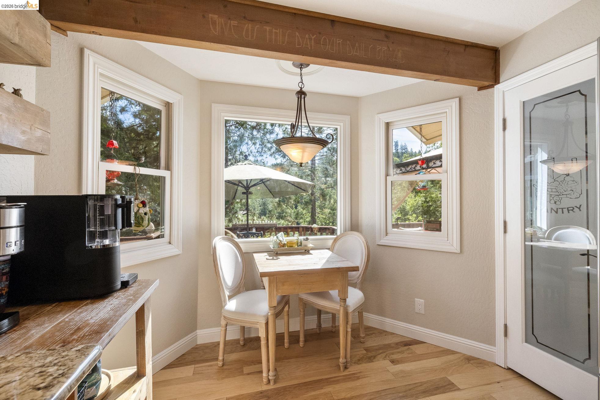 20581 Gerber Road Tuolumne, CA 95379 - Photo 11 of 60 Dining room with light wood-style flooring, beamed ceiling, and a textured wall