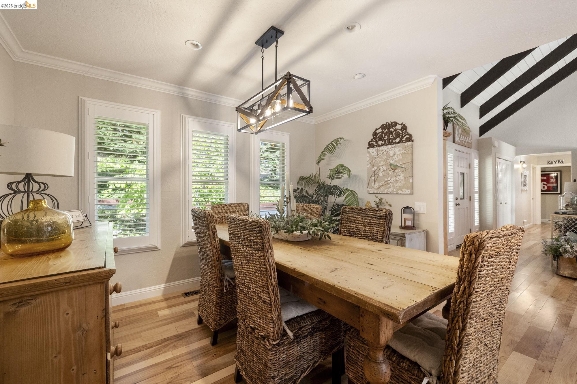 20581 Gerber Road Tuolumne, CA 95379 - Photo 14 of 60 Dining room with light wood-style floors, vaulted ceiling, ornamental molding, and a chandelier