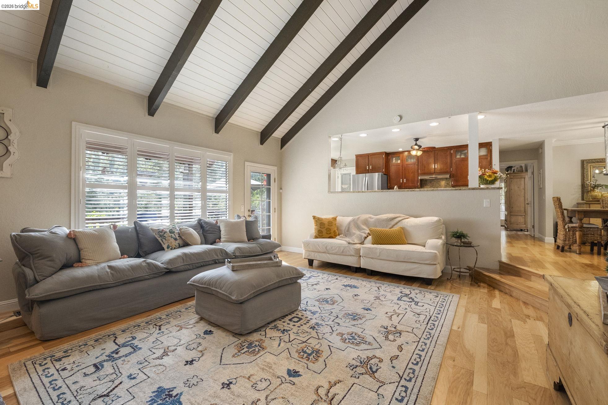 20581 Gerber Road Tuolumne, CA 95379 - Photo 17 of 60 Living area featuring high vaulted ceiling, light wood finished floors, beam ceiling, and ceiling fan