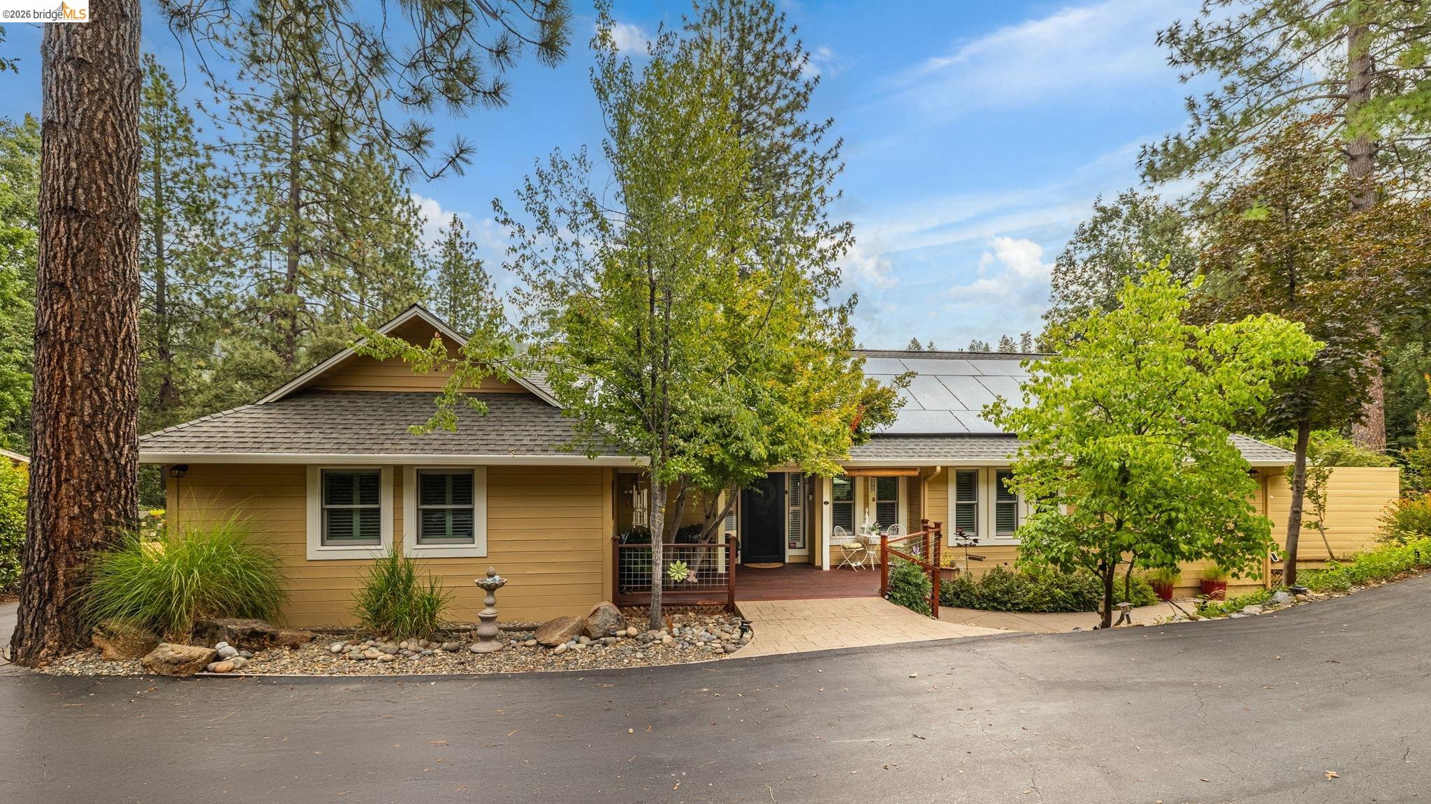 20581 Gerber Road Tuolumne, CA 95379 - Photo 2 of 60 View of front facade with a deck, a shingled roof, and roof mounted solar panels