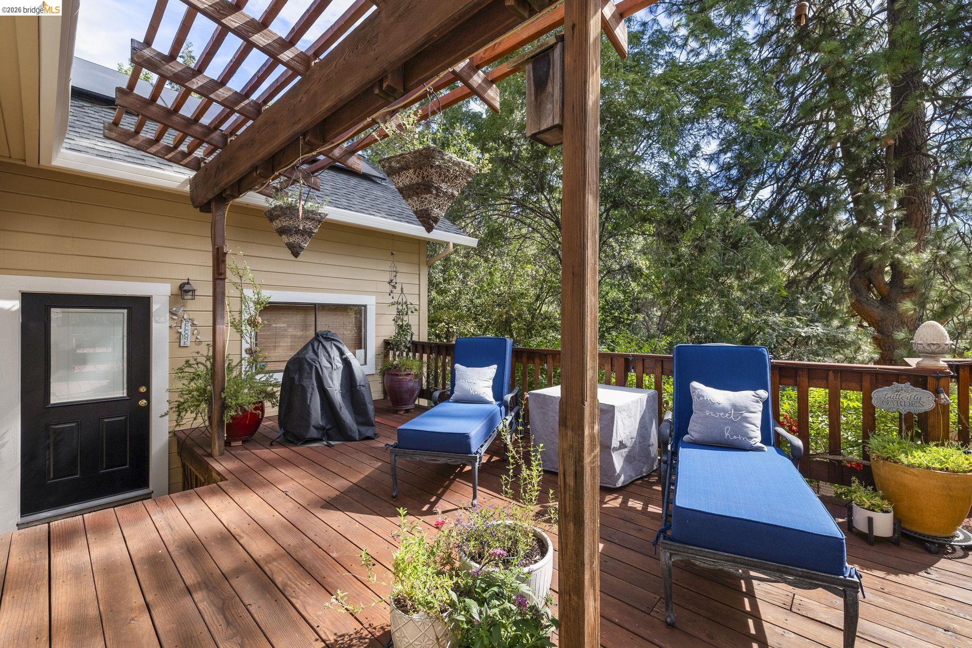 20581 Gerber Road Tuolumne, CA 95379 - Photo 27 of 60 Wooden terrace with grilling area and view of wooded area