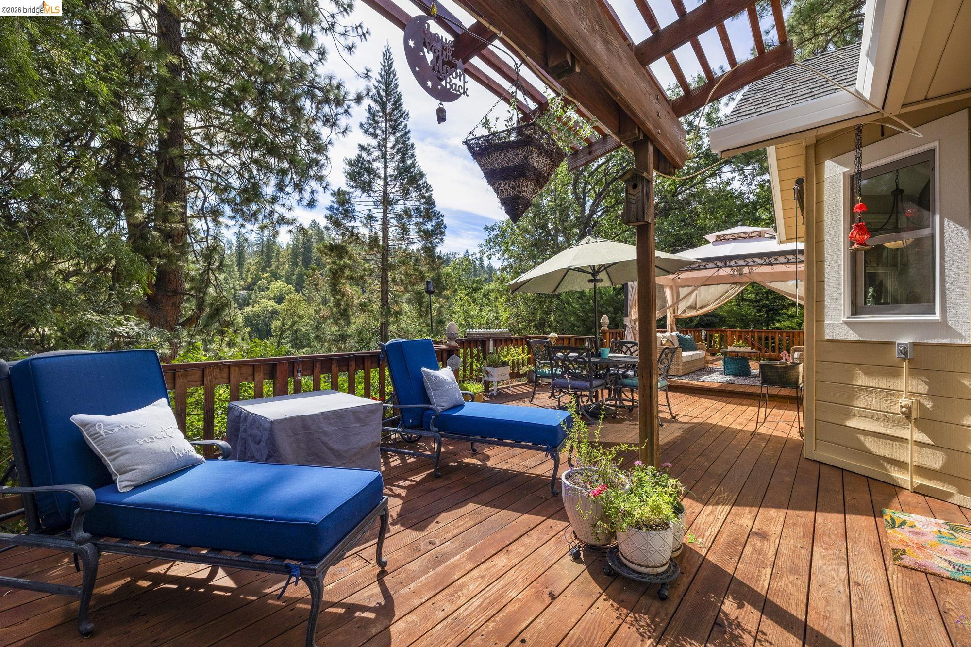 20581 Gerber Road Tuolumne, CA 95379 - Photo 28 of 60 Wooden deck with a gazebo, an outdoor hangout area, and outdoor dining space