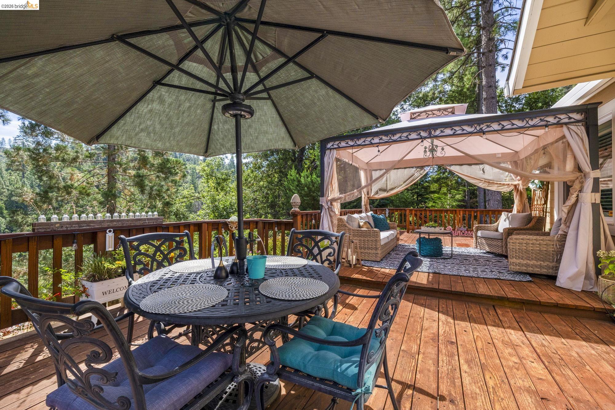 20581 Gerber Road Tuolumne, CA 95379 - Photo 29 of 60 Wooden deck featuring a gazebo, outdoor lounge area, and outdoor dining space