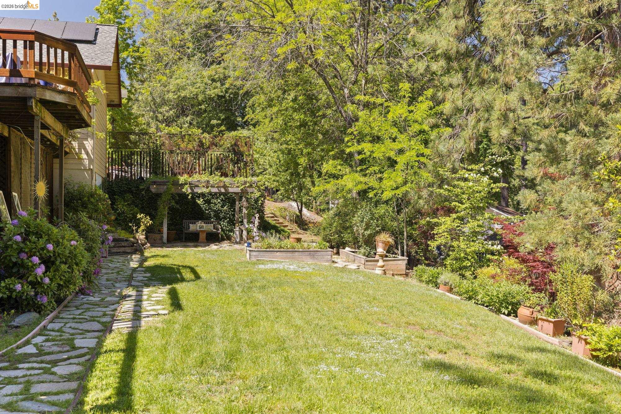 20581 Gerber Road Tuolumne, CA 95379 - Photo 39 of 60 View of grassy yard with stairway, a deck, and a patio area