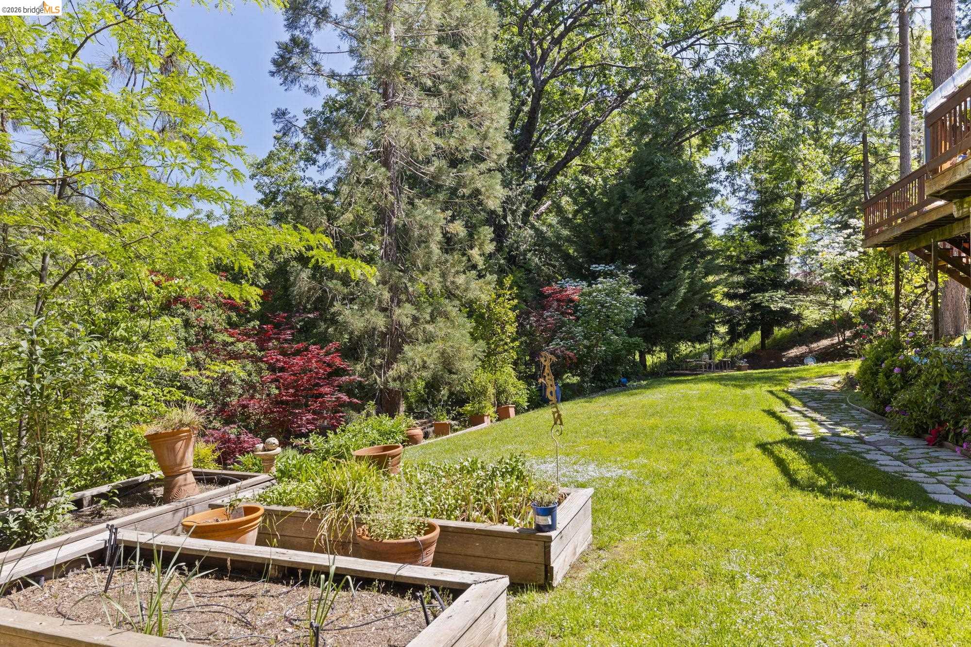 20581 Gerber Road Tuolumne, CA 95379 - Photo 44 of 60 View of green lawn with a vegetable garden and a deck