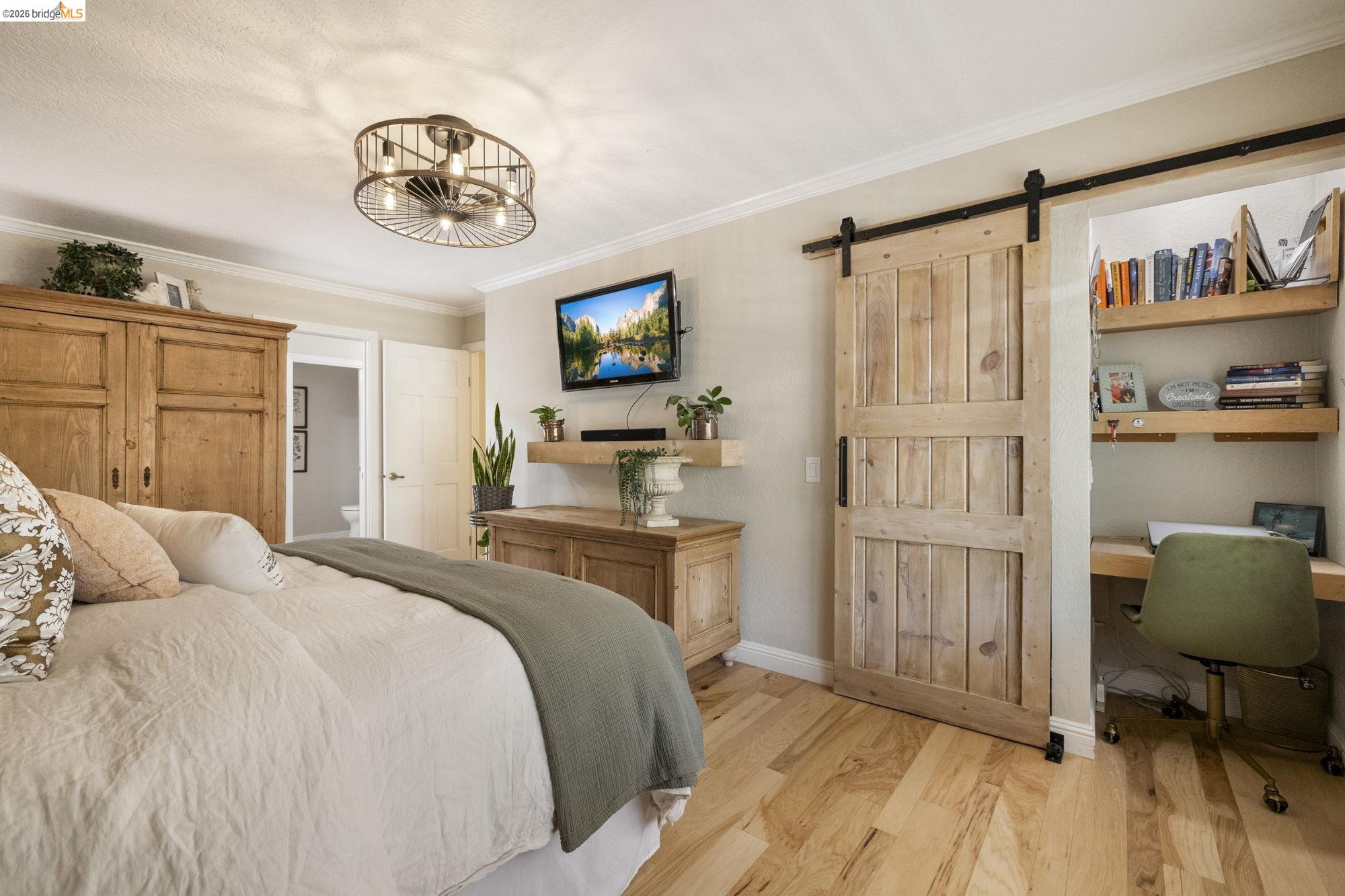 20581 Gerber Road Tuolumne, CA 95379 - Photo 5 of 60 Bedroom with ornamental molding, wood finished floors, a barn door, and an office area