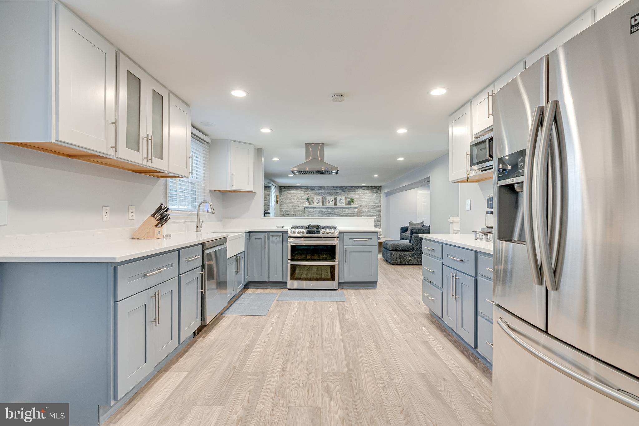 8501 Aqueduct Road Potomac, MD 20854 - Photo 14 of 54 a kitchen with stainless steel appliances a stove top oven a sink and a refrigerator
