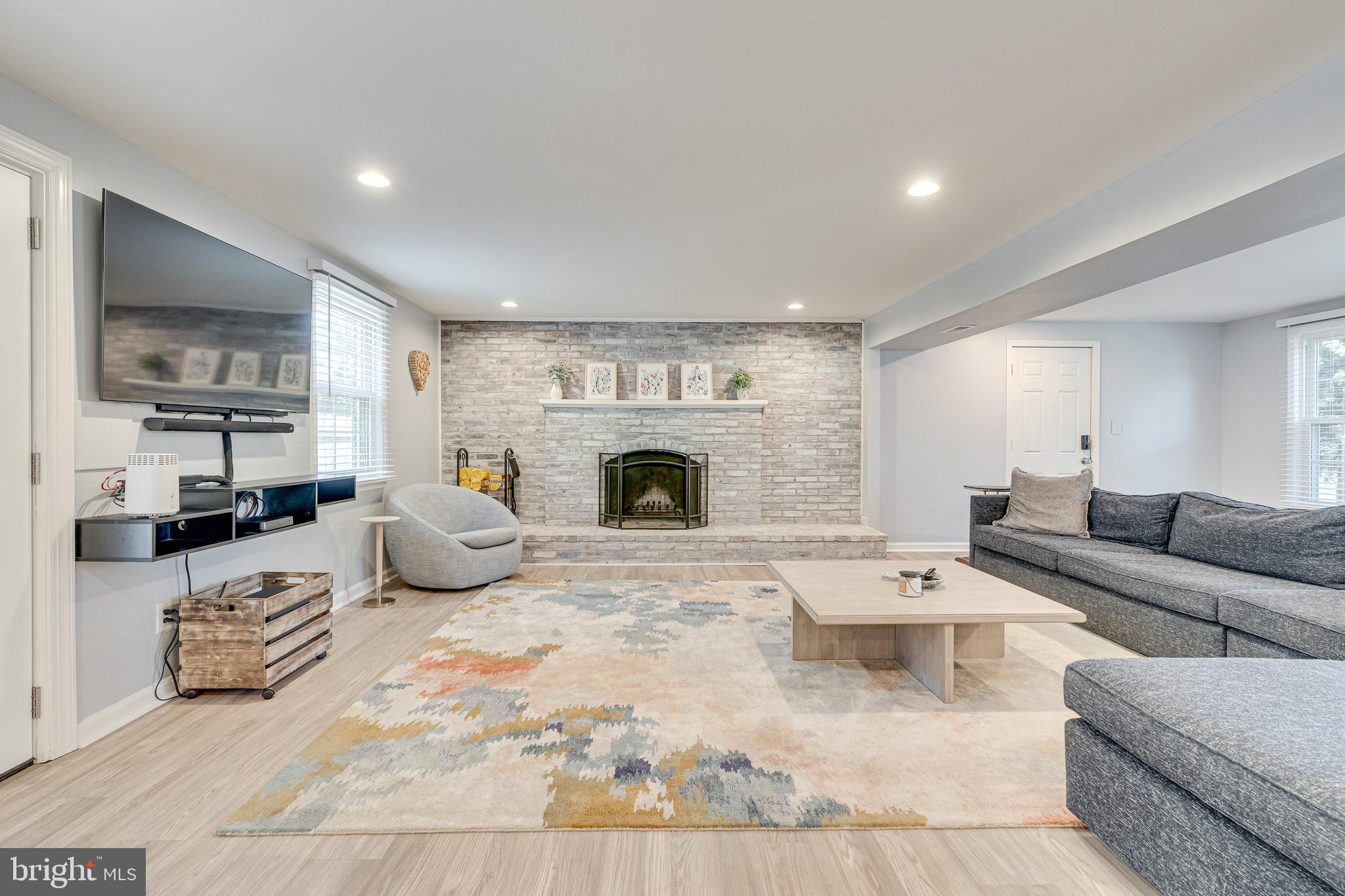 8501 Aqueduct Road Potomac, MD 20854 - Photo 14 of 75 a living room with furniture fireplace and flat screen tv