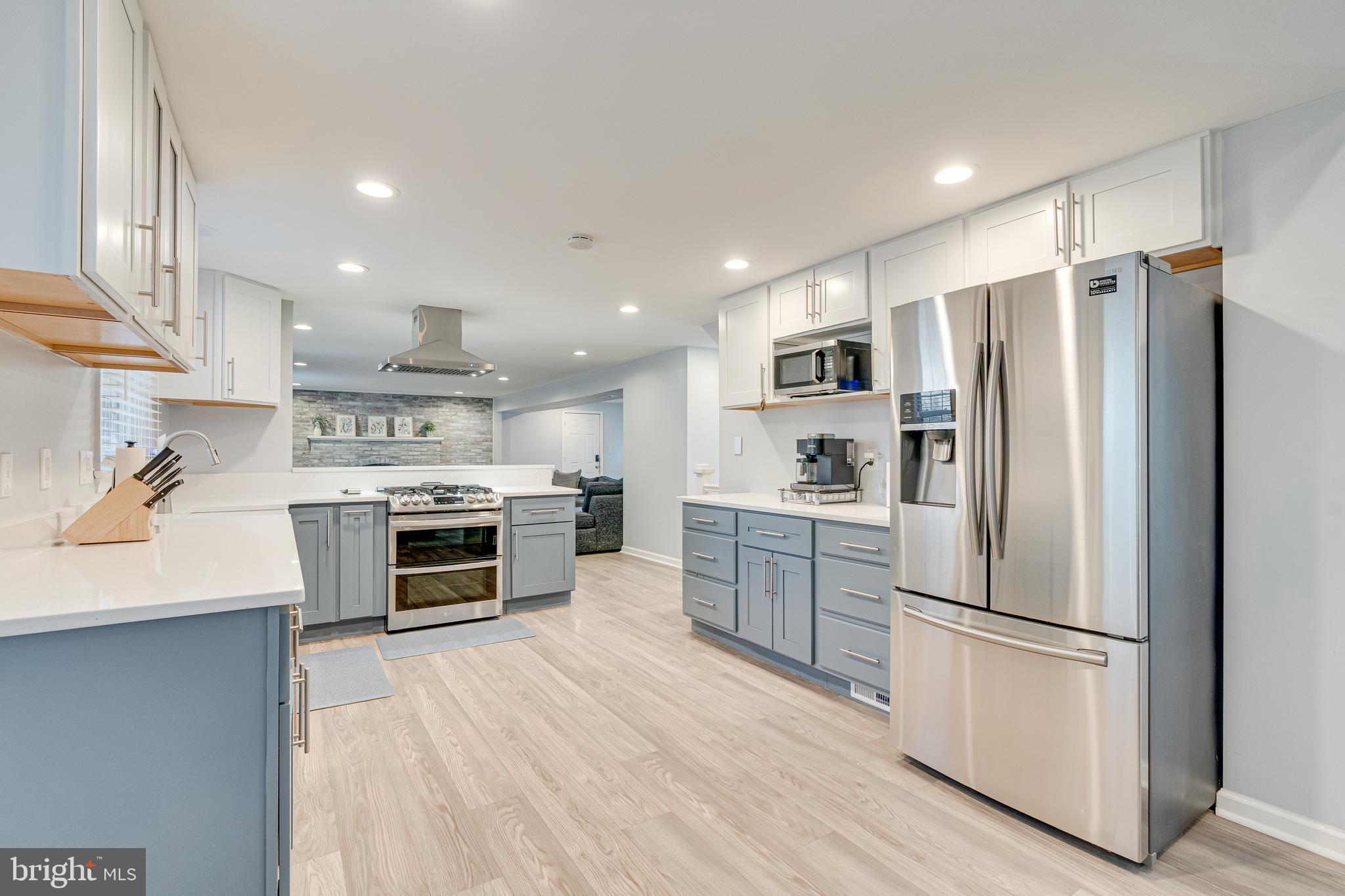 8501 Aqueduct Road Potomac, MD 20854 - Photo 15 of 54 a kitchen with stainless steel appliances a refrigerator sink and stove top oven