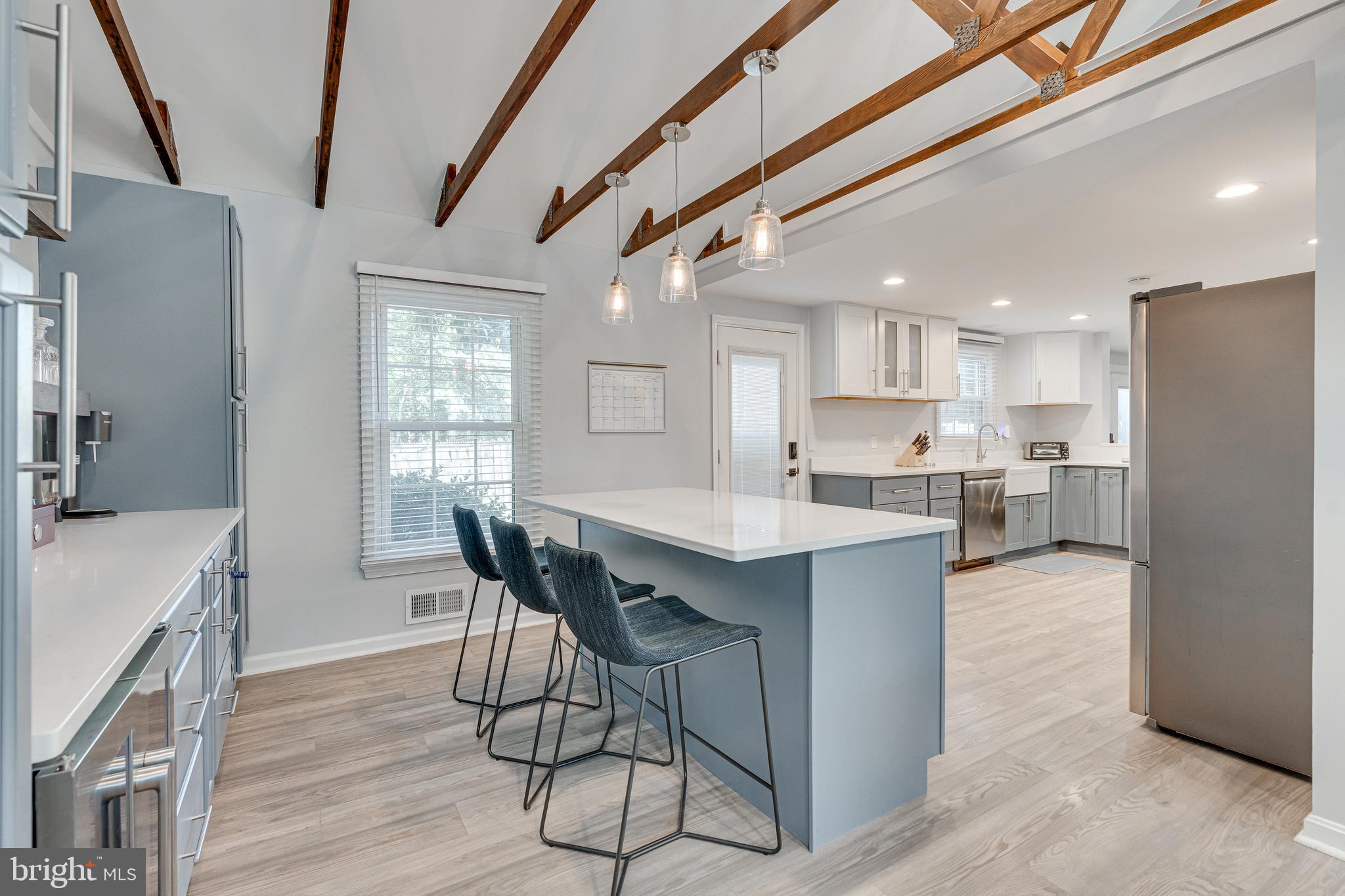 8501 Aqueduct Road Potomac, MD 20854 - Photo 20 of 54 a kitchen with stainless steel appliances kitchen island a table chairs in it and wooden floors