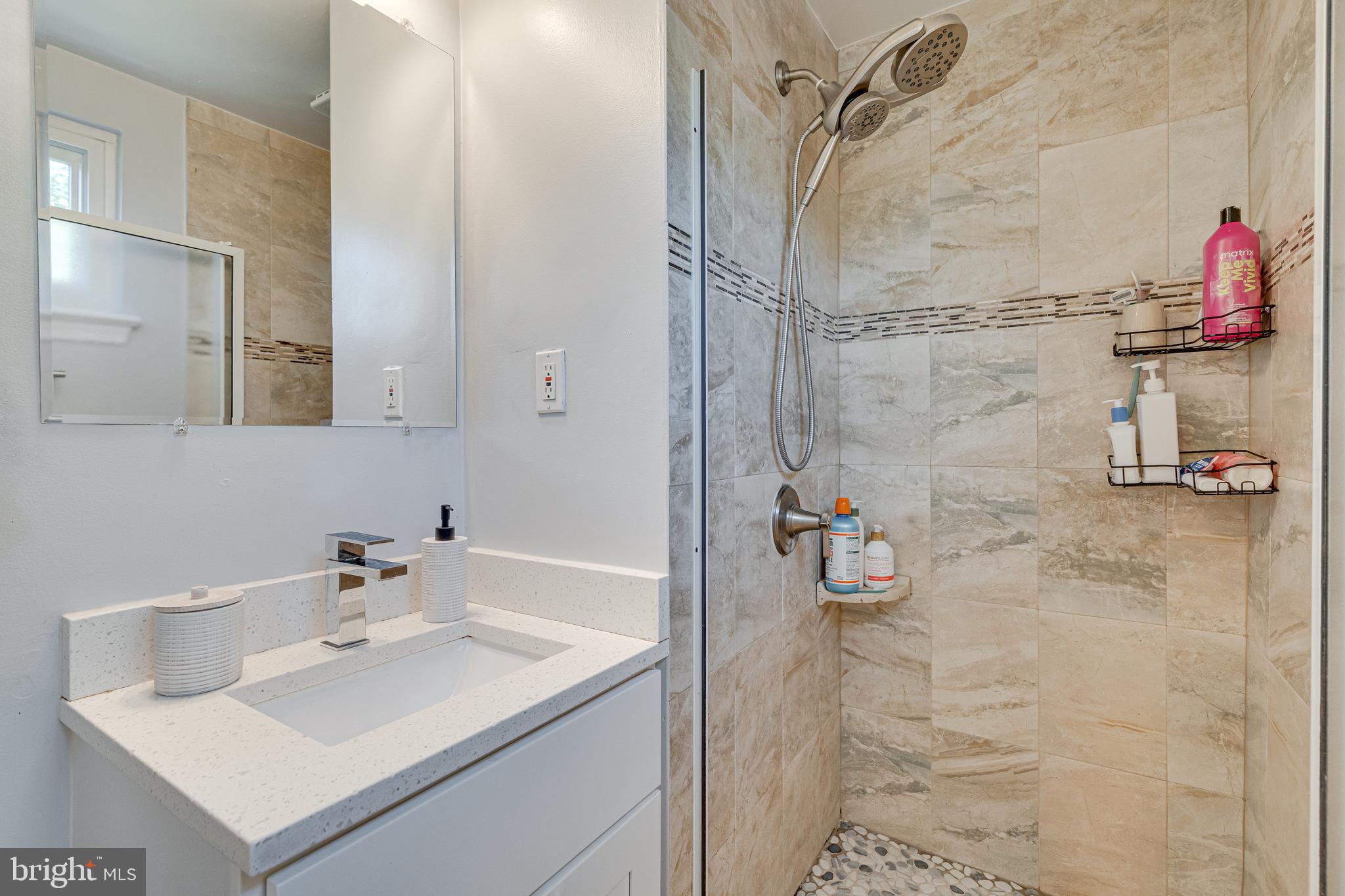8501 Aqueduct Road Potomac, MD 20854 - Photo 28 of 54 a bathroom with a sink vanity and a shower