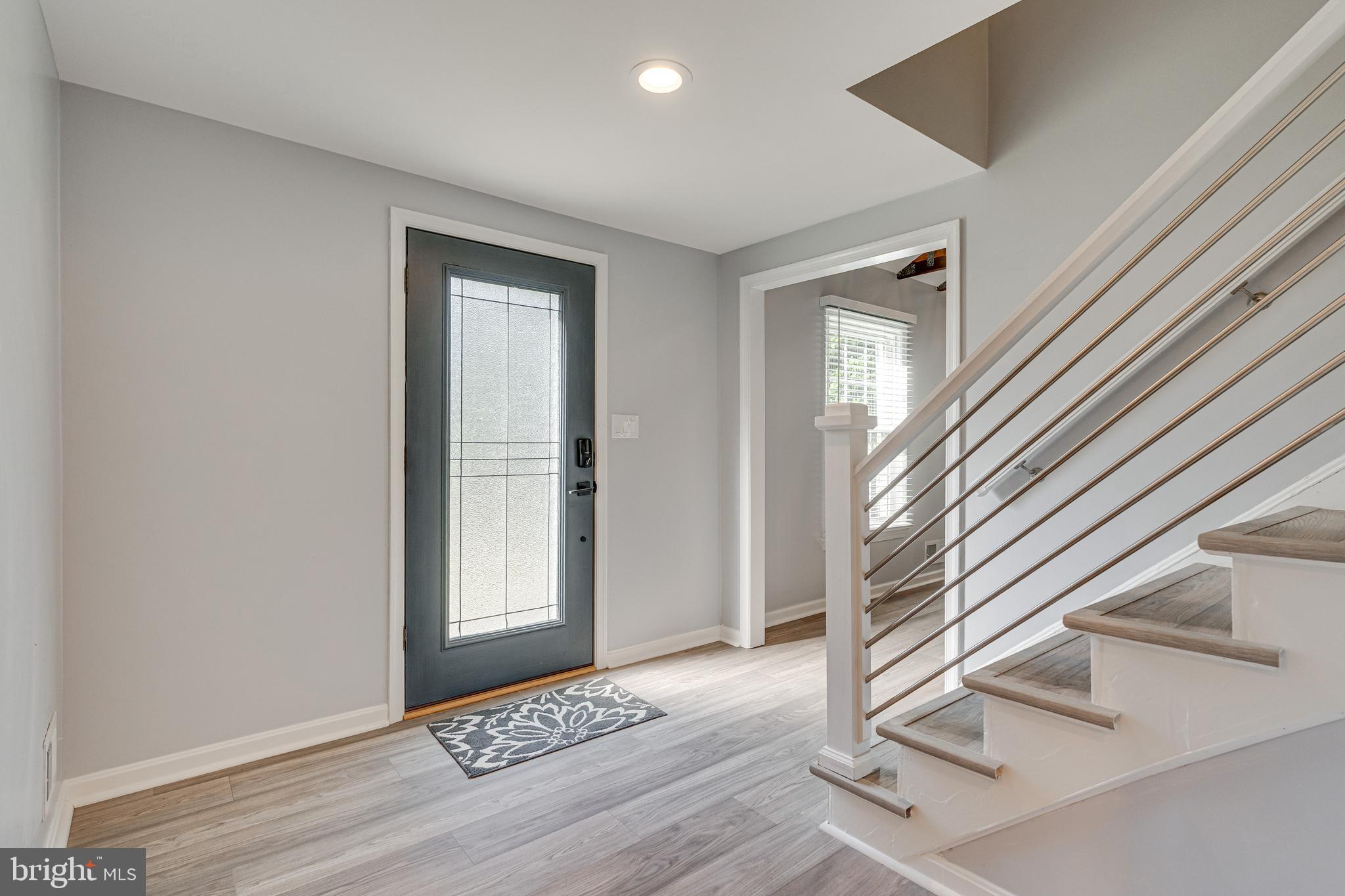 8501 Aqueduct Road Potomac, MD 20854 - Photo 6 of 54 a view of a hallway with wooden floor and staircase