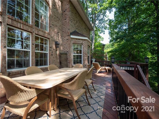 1350 Crown Ridge Drive Fort Mill, SC 29708 - Photo 2 of 3 a view of a patio with table and chairs with wooden floor and fence