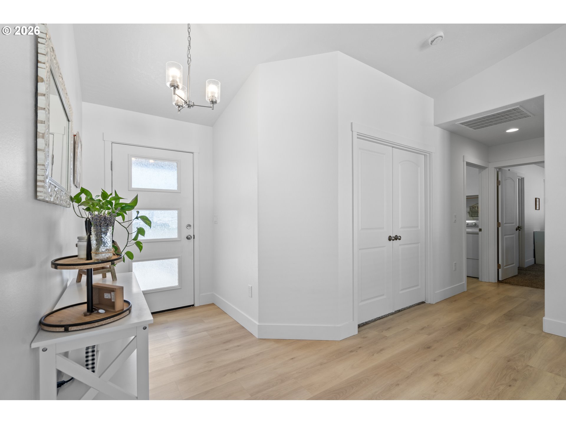 306 Sage Street Boardman, OR 97818 - Photo 12 of 24 a view of a hallway with wooden floor and a chandelier