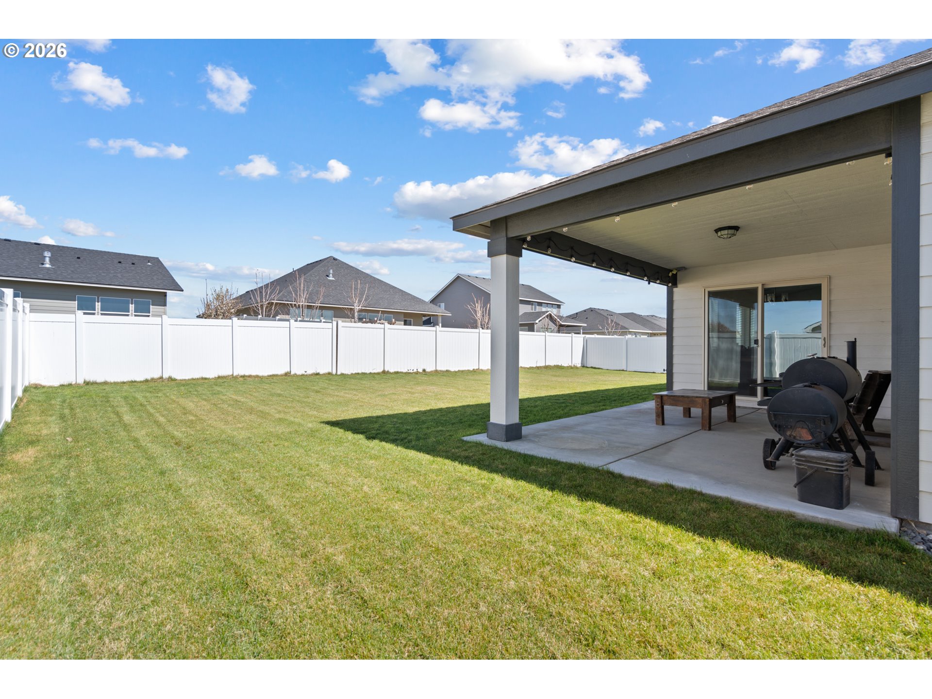 306 Sage Street Boardman, OR 97818 - Photo 20 of 24 a backyard of a house with table and chairs